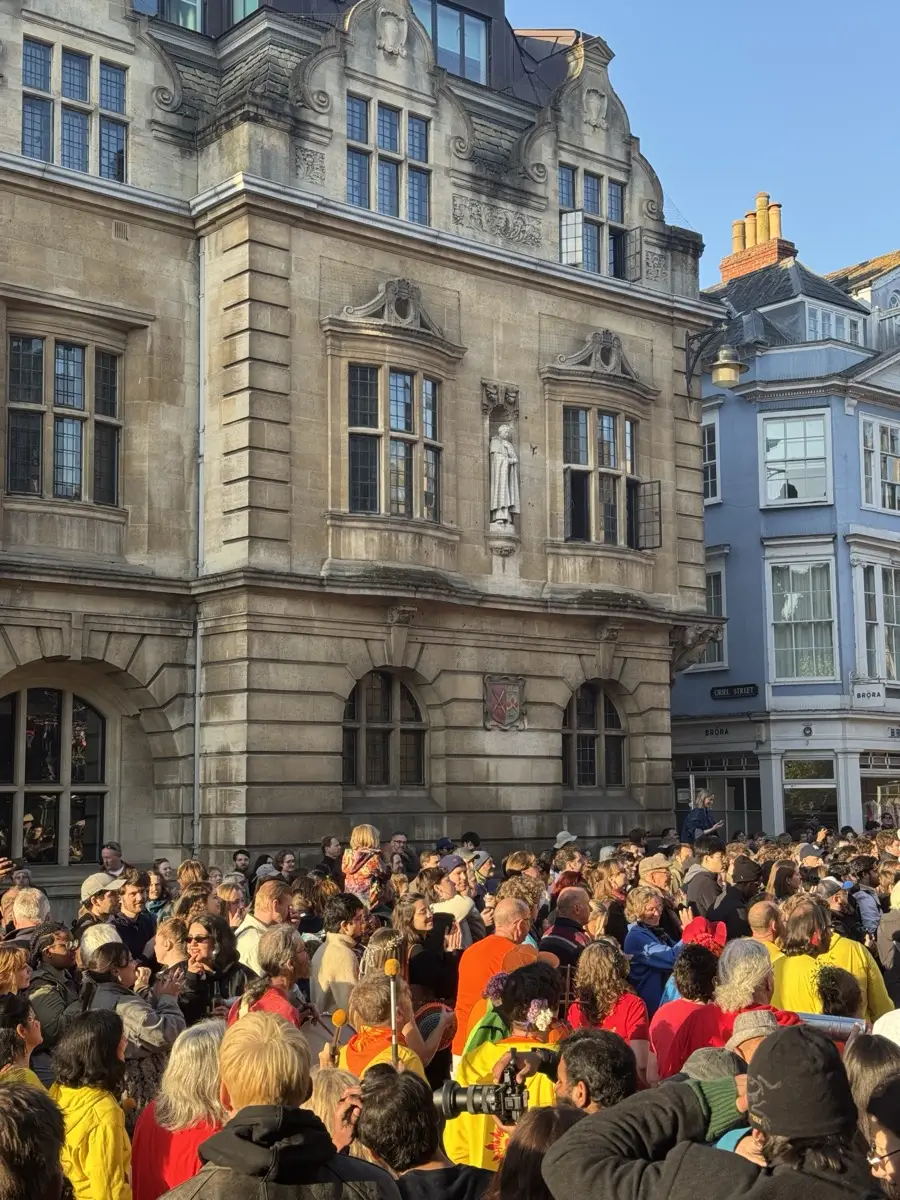 Dancers in colourful kit perform on the street on May Morning 2026